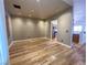 Spacious living room with wood-look floors, recessed lighting, and neutral wall paint at 4126 Jessica Marie St, North Las Vegas, NV 89032