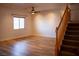 A bright, open living room features wood-look flooring, a ceiling fan and natural light at 4126 Jessica Marie St, North Las Vegas, NV 89032