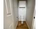 Compact powder room featuring a standard toilet, overhead storage, and wood-look flooring at 4126 Jessica Marie St, North Las Vegas, NV 89032