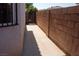 Side walkway shows a concrete path bordered by a brick wall and the side of the house at 4126 Jessica Marie St, North Las Vegas, NV 89032