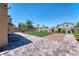 Spacious backyard with pavers, turf, and minimal landscaping for easy maintenance at 4206 Topaz Hills Dr, North Las Vegas, NV 89032