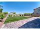 Landscaped backyard featuring artificial turf and paved patio at 4206 Topaz Hills Dr, North Las Vegas, NV 89032