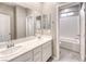 Bathroom featuring double sinks with white cabinets and a separate shower/tub area at 4206 Topaz Hills Dr, North Las Vegas, NV 89032