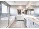 Bright bathroom with dual vanities and a glass-enclosed shower and tub at 4206 Topaz Hills Dr, North Las Vegas, NV 89032