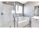 Modern bathroom featuring a glass-enclosed shower and separate soaking tub at 4206 Topaz Hills Dr, North Las Vegas, NV 89032