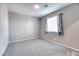 Bright bedroom featuring neutral carpet, window with coverings, and light paint at 4206 Topaz Hills Dr, North Las Vegas, NV 89032