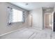 Spacious bedroom featuring neutral carpet, natural lighting, and an open doorway at 4206 Topaz Hills Dr, North Las Vegas, NV 89032