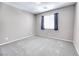 Cozy bedroom with plush carpet, window with coverings, and light neutral paint at 4206 Topaz Hills Dr, North Las Vegas, NV 89032