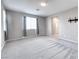 Neutral bedroom with large windows, TV mount, and soft carpeting at 4206 Topaz Hills Dr, North Las Vegas, NV 89032