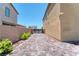 Long driveway with decorative pavers leading to a gate at 4206 Topaz Hills Dr, North Las Vegas, NV 89032