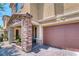 Close-up of home featuring brick accents on the porch, stone base columns, and two car garage at 4206 Topaz Hills Dr, North Las Vegas, NV 89032