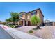 Two-story house with brick accents, a two-car garage, and attractive landscaping at 4206 Topaz Hills Dr, North Las Vegas, NV 89032