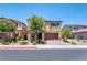 Two-story house with a brick-accented porch and a two car garage at 4206 Topaz Hills Dr, North Las Vegas, NV 89032