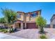 Two-story home with a brick-accented porch and a well-maintained front yard at 4206 Topaz Hills Dr, North Las Vegas, NV 89032