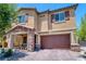 Charming two-story home featuring a stone-accented porch and a two-car garage with brick-paved driveway at 4206 Topaz Hills Dr, North Las Vegas, NV 89032
