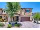 Attractive two-story house with a stone-accented porch, two-car garage, and desert landscaping at 4206 Topaz Hills Dr, North Las Vegas, NV 89032