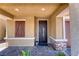 Charming front porch with decorative stone accents and an ornate door at 4206 Topaz Hills Dr, North Las Vegas, NV 89032