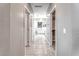 Hallway leading to bathroom with tile floors and modern lighting at 4206 Topaz Hills Dr, North Las Vegas, NV 89032