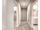 Hallway with wood-style floors leading to various rooms with white doors and casings at 4206 Topaz Hills Dr, North Las Vegas, NV 89032