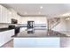 Open kitchen featuring a central island, sleek black appliances, and white cabinets, blending style and functionality at 4206 Topaz Hills Dr, North Las Vegas, NV 89032