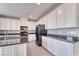 Modern kitchen with white cabinets, dark countertops, and black appliances at 4206 Topaz Hills Dr, North Las Vegas, NV 89032
