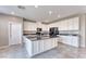 Bright kitchen with a large island, black appliances, white cabinets, and ample counter space at 4206 Topaz Hills Dr, North Las Vegas, NV 89032