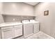 Laundry room with washer, dryer, shelving, and cabinetry at 4206 Topaz Hills Dr, North Las Vegas, NV 89032
