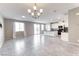 Open-concept living room and kitchen with tile floors and modern chandelier at 4206 Topaz Hills Dr, North Las Vegas, NV 89032