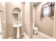 Charming powder room featuring pedestal sink and classic fixtures at 4206 Topaz Hills Dr, North Las Vegas, NV 89032