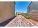 Paver-stone side yard with low-maintenance landscaping and views of the neighbor's homes at 4206 Topaz Hills Dr, North Las Vegas, NV 89032
