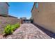 Paver-stone side yard with low-maintenance landscaping and view of street at 4206 Topaz Hills Dr, North Las Vegas, NV 89032