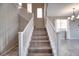 Elegant staircase with white railing and wood treads at 4206 Topaz Hills Dr, North Las Vegas, NV 89032