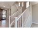 Bright foyer with wooden staircase and white banisters leading to the upper level at 4206 Topaz Hills Dr, North Las Vegas, NV 89032