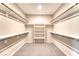 Well-organized walk-in closet with shelves and rods for storage at 4206 Topaz Hills Dr, North Las Vegas, NV 89032