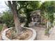 Charming backyard patio with a pergola covered in flowering vines at 4444 Denia Cir, Las Vegas, NV 89108