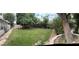 Expansive backyard featuring lush lawn, mature trees, and a stone-lined walkway by the house at 4444 Denia Cir, Las Vegas, NV 89108