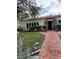 Single-story home with classic design, a brick walkway, and charming front yard landscaping at 4444 Denia Cir, Las Vegas, NV 89108