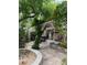 Landscaped patio with stone pavers, a pergola, and a built-in grill at 4444 Denia Cir, Las Vegas, NV 89108