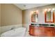 Bathroom with a double vanity, granite counters, and soaking tub at 4525 Dean Martin Dr # 2203, Las Vegas, NV 89103