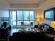 Cozy living room with hardwood floors, sleek furniture, and a stunning city view through a large window at 4525 Dean Martin Dr # 2203, Las Vegas, NV 89103