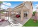 Outdoor patio with covered area, lush artificial turf, barbecue, and outdoor furniture at 5234 Tulip Hill Ave, Las Vegas, NV 89141