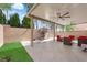 Outdoor patio with covered area, lush artificial turf, barbecue, and outdoor furniture at 5234 Tulip Hill Ave, Las Vegas, NV 89141