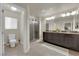 Spacious bathroom with double vanity, tiled floors, and glass enclosed shower at 5234 Tulip Hill Ave, Las Vegas, NV 89141