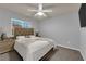 Relaxing bedroom with a plush bed, ceiling fan, and natural light from the bright window at 5234 Tulip Hill Ave, Las Vegas, NV 89141