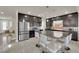 Modern kitchen features dark cabinets, stainless steel appliances, granite counters and large island with seating at 5234 Tulip Hill Ave, Las Vegas, NV 89141