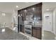 Modern kitchen boasts stainless steel appliances, granite counters, and dark wood cabinetry at 5234 Tulip Hill Ave, Las Vegas, NV 89141