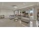 Bright living room with tile flooring, comfortable seating, and abundant natural light from large windows at 5234 Tulip Hill Ave, Las Vegas, NV 89141