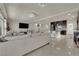 Spacious living room featuring tile flooring, modern lighting, and a sleek entertainment center at 5234 Tulip Hill Ave, Las Vegas, NV 89141