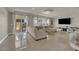 Bright living room featuring tile flooring, comfortable seating, and sliding glass doors to the backyard at 5234 Tulip Hill Ave, Las Vegas, NV 89141