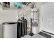 Utility room includes water tanks and heater, shelving units and a door at 5234 Tulip Hill Ave, Las Vegas, NV 89141